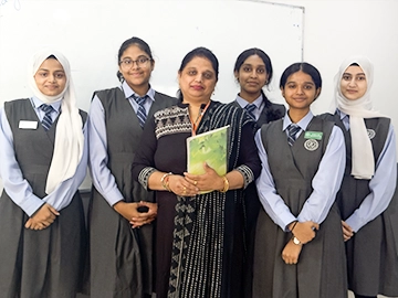 best secondary education Kuwait teacher with female students in uniform
