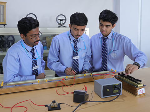 Indian high school Kuwait teacher explaining lesson to attentive students